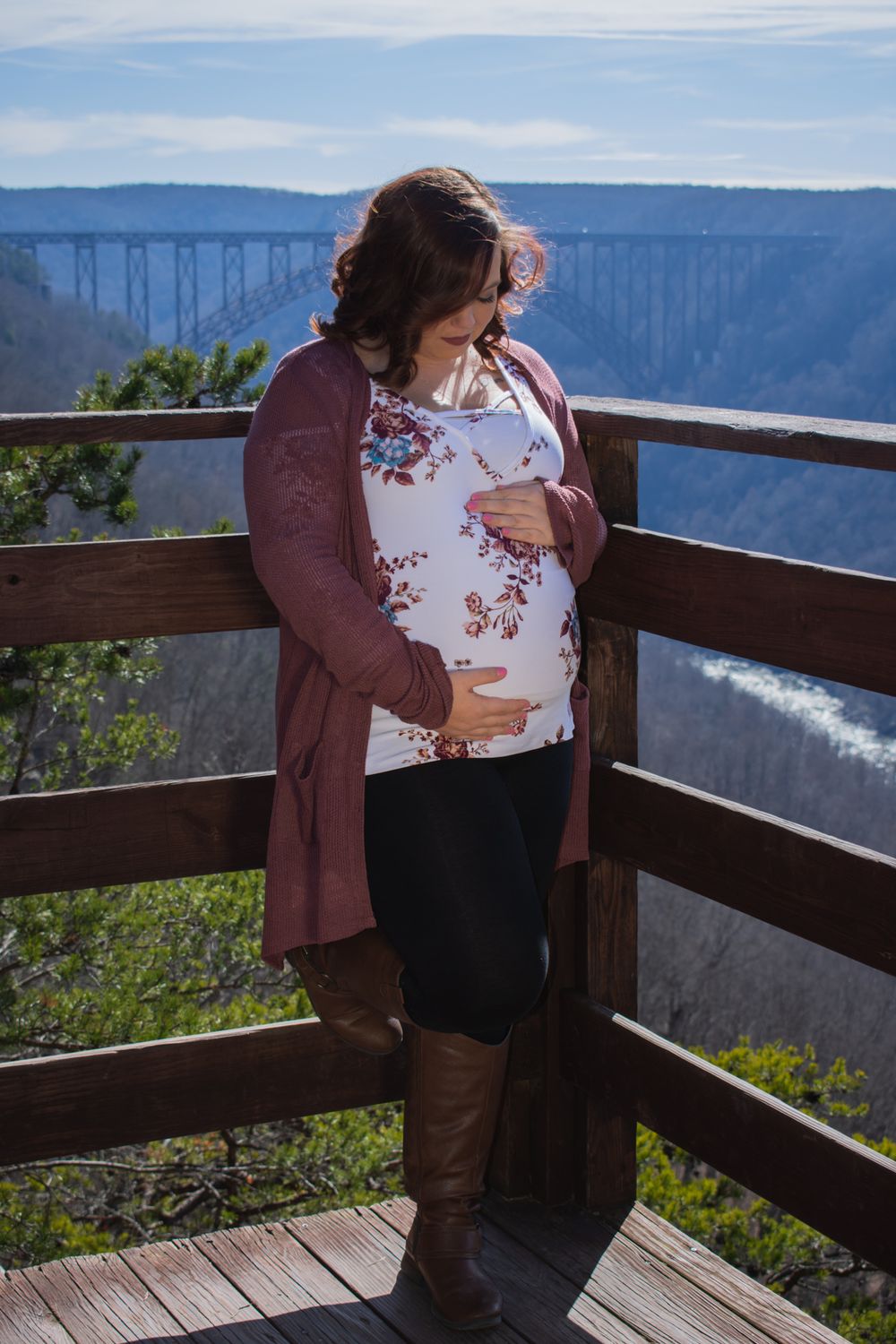 Maternity photos on mountain overlook deck with scenic valley view.