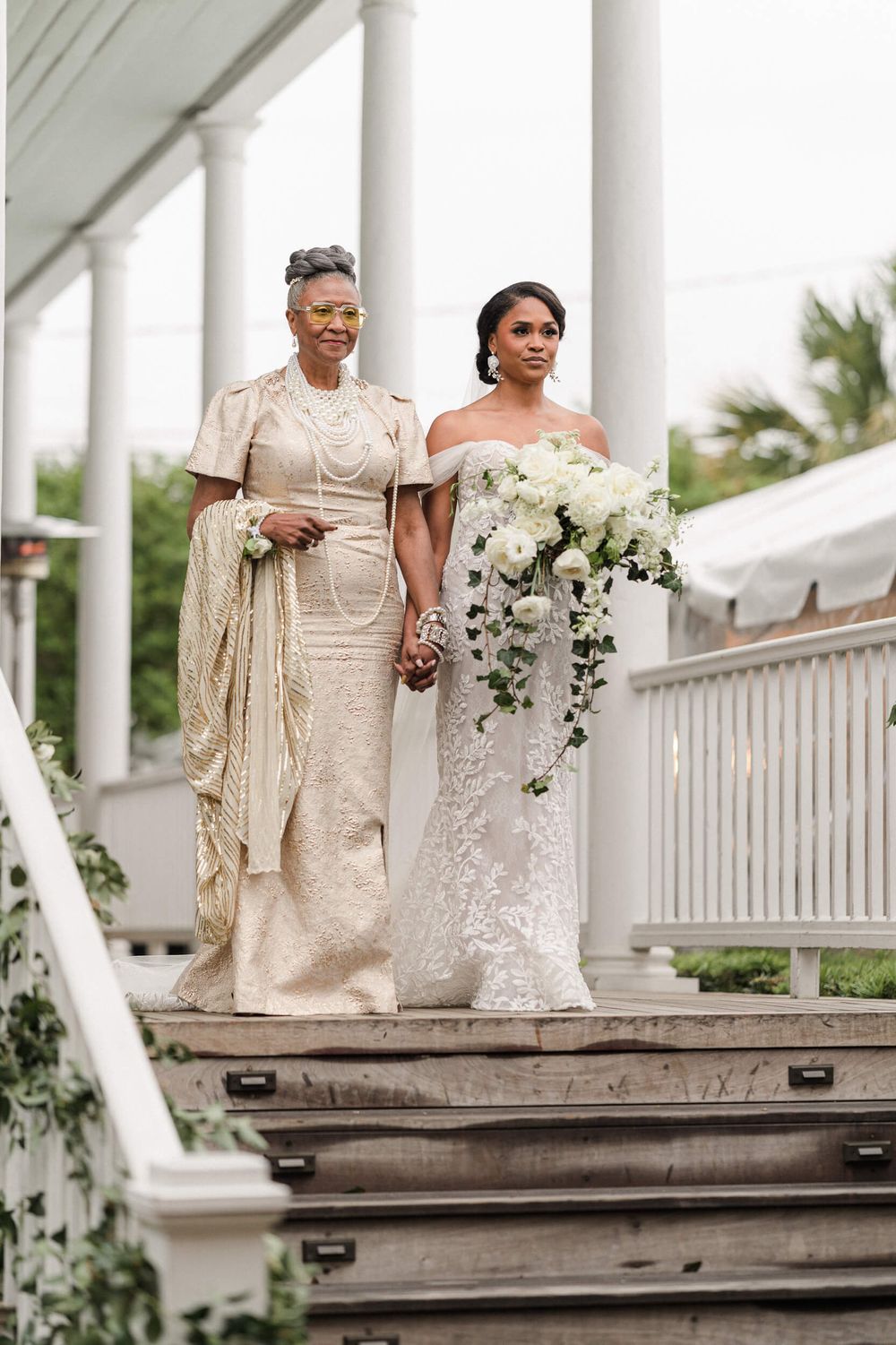 White floral wedding ceremony aisle featuring elegant formal attire.