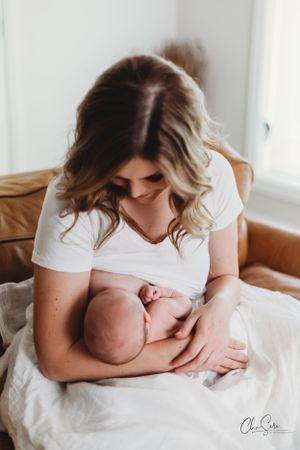 Lifestyle photography series of tender nursing moments in natural light.