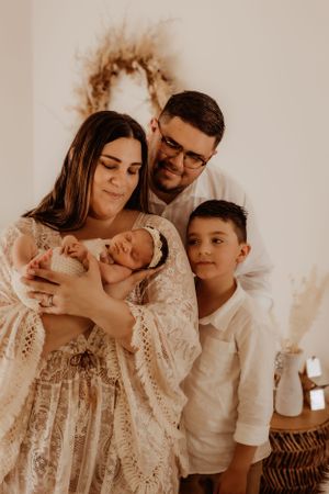 Family sharing intimate moment together in warm sepia tones.