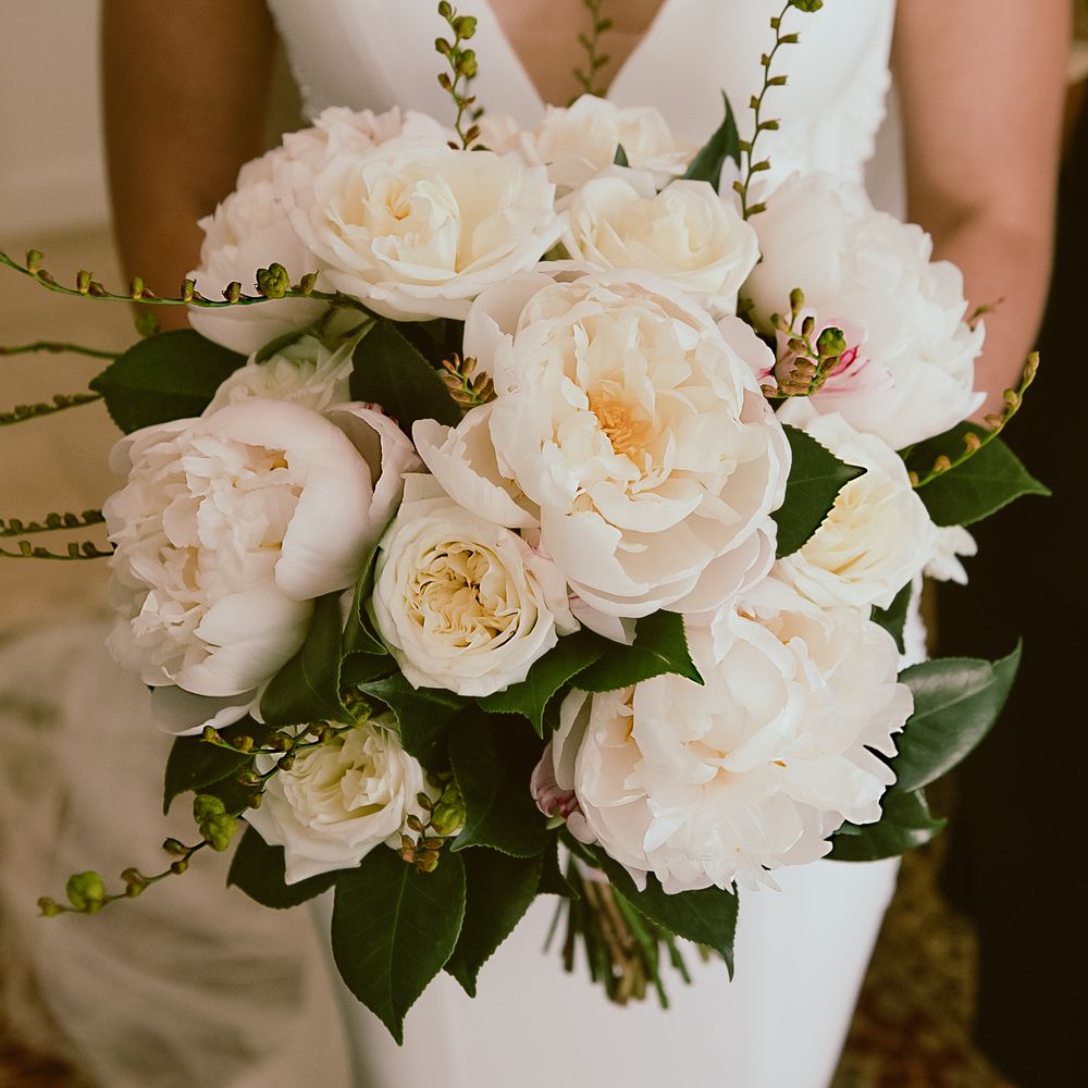 A bride holding her bridal bouquet.