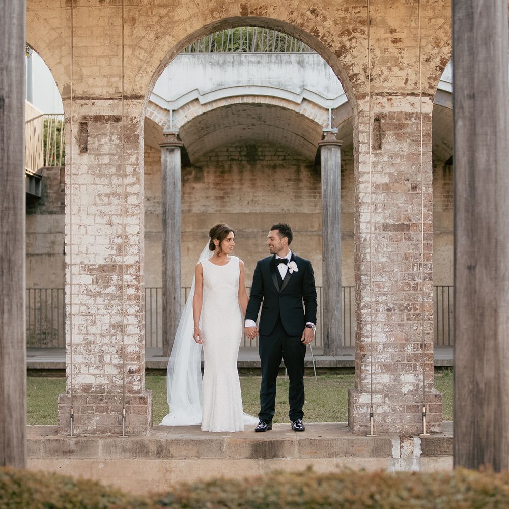 Bride and groom holding hands in their photoshoot.