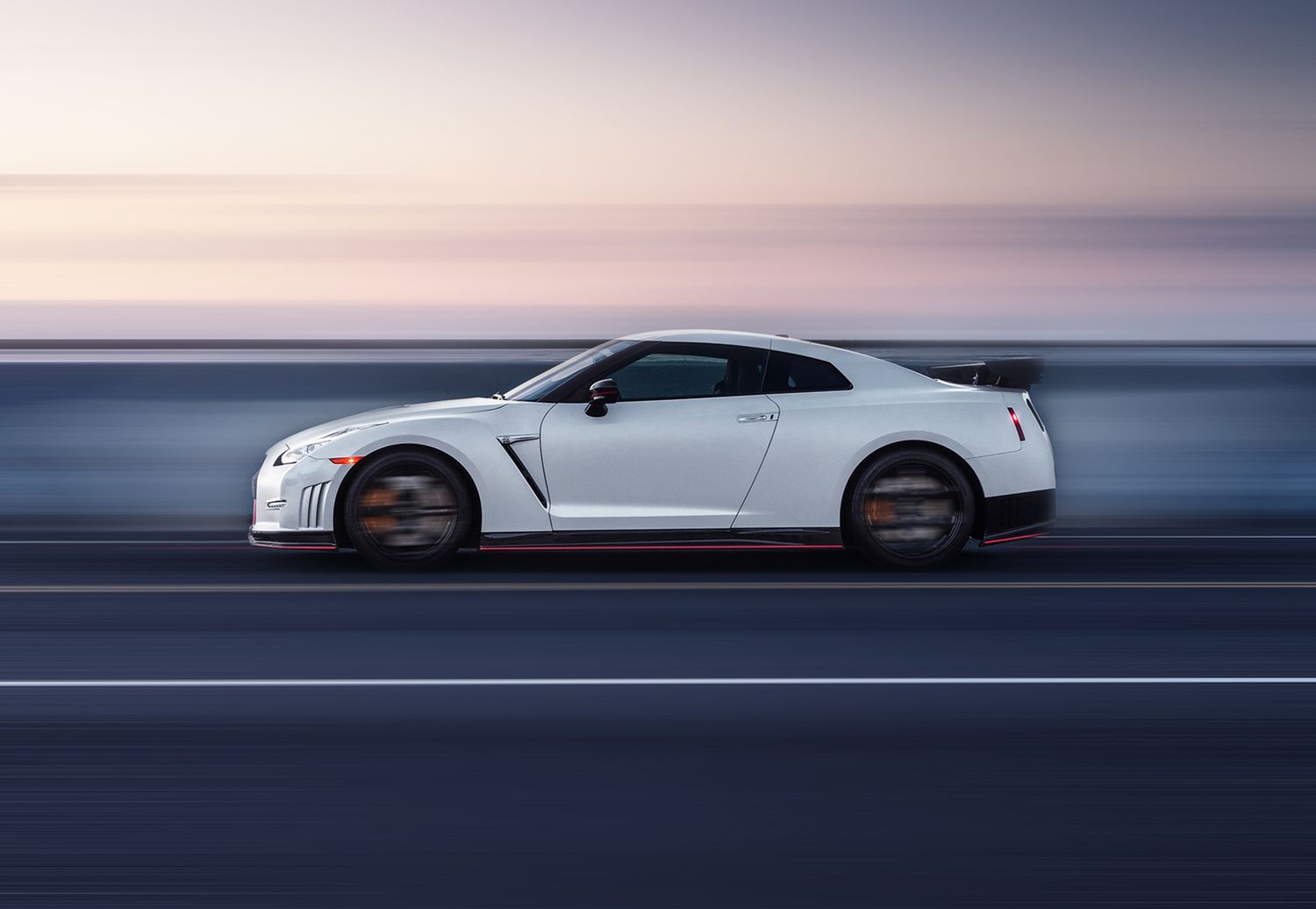 Motion blur shot of cars driving on highway during sunset or sunrise.
