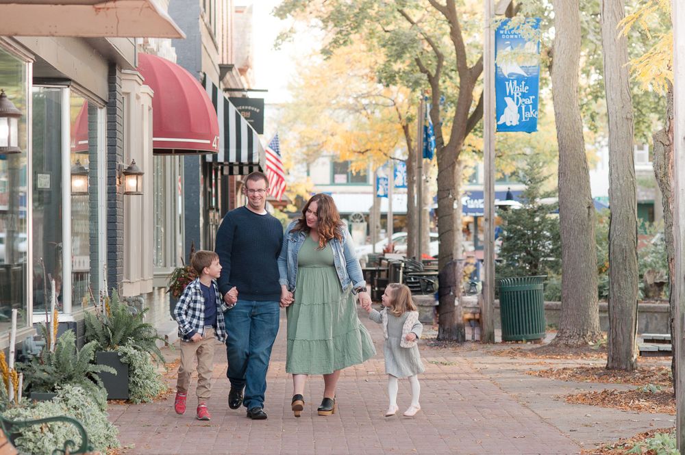 Downtown White Bear Lake Minnesota Family Child Photographer Twin Cities Stillwater family walking together through downtown White Bear Lake