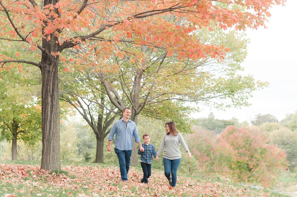 Stillwater Minneapolis Minnesota Family Photographer fall leaves and family walking together at sunset