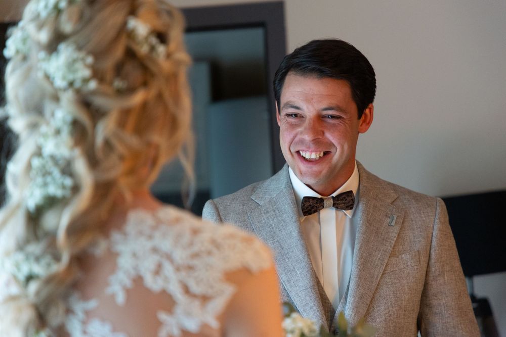 Joyful wedding moment captured during first look between couple.