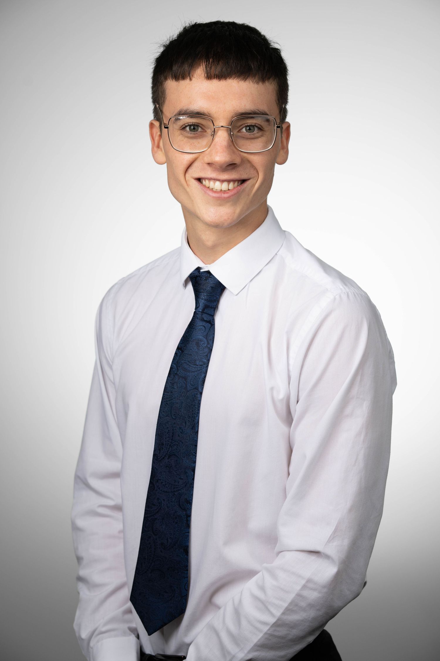 Business portrait of a man against a plain background