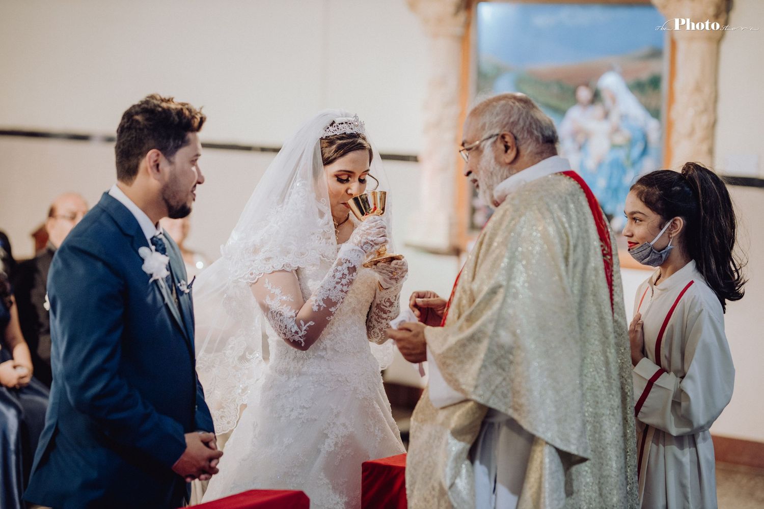Wedding celebration with guests and couple in a bright indoor venue.