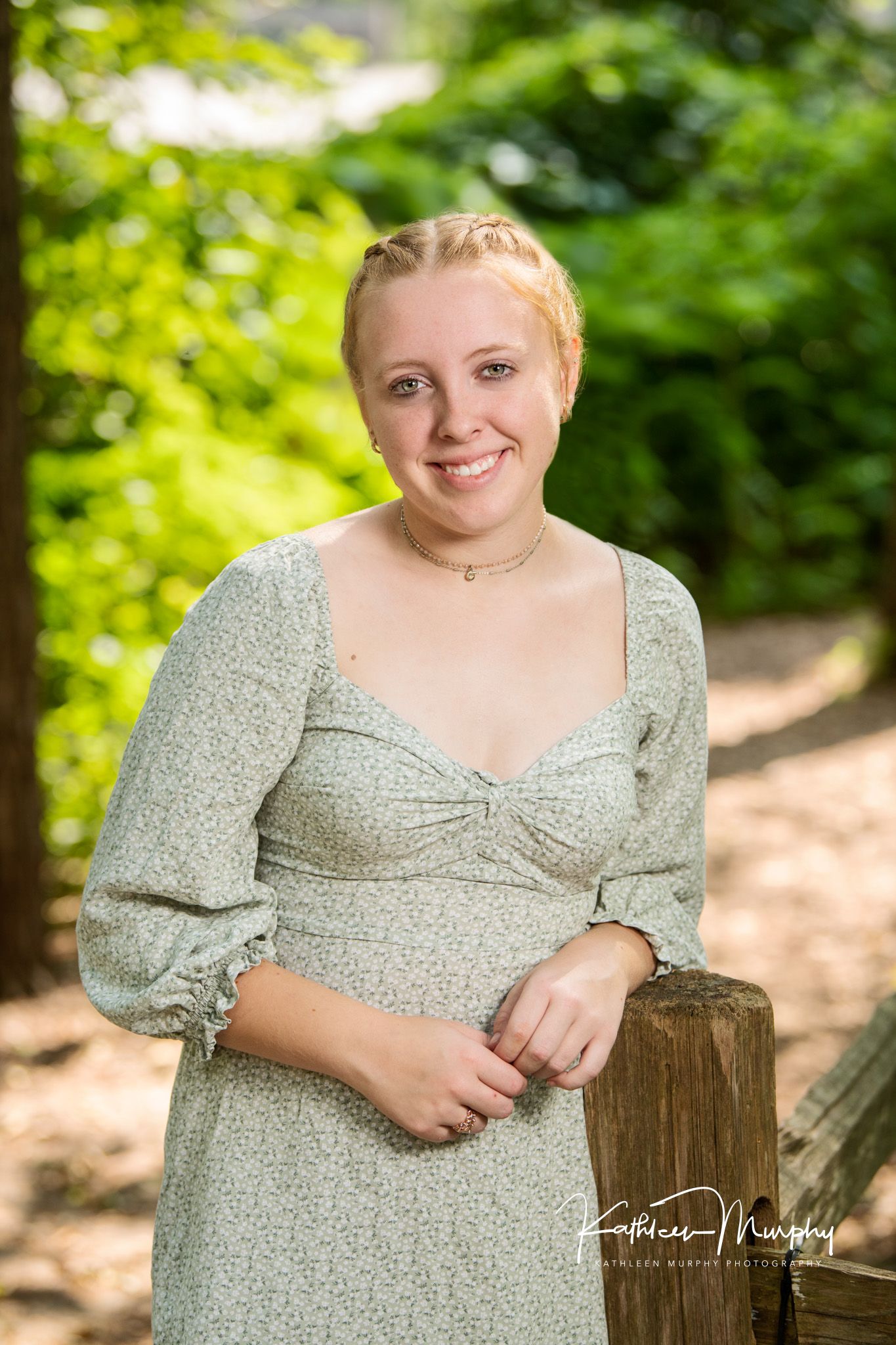 teen girl with hair braide in a soft green sundress
