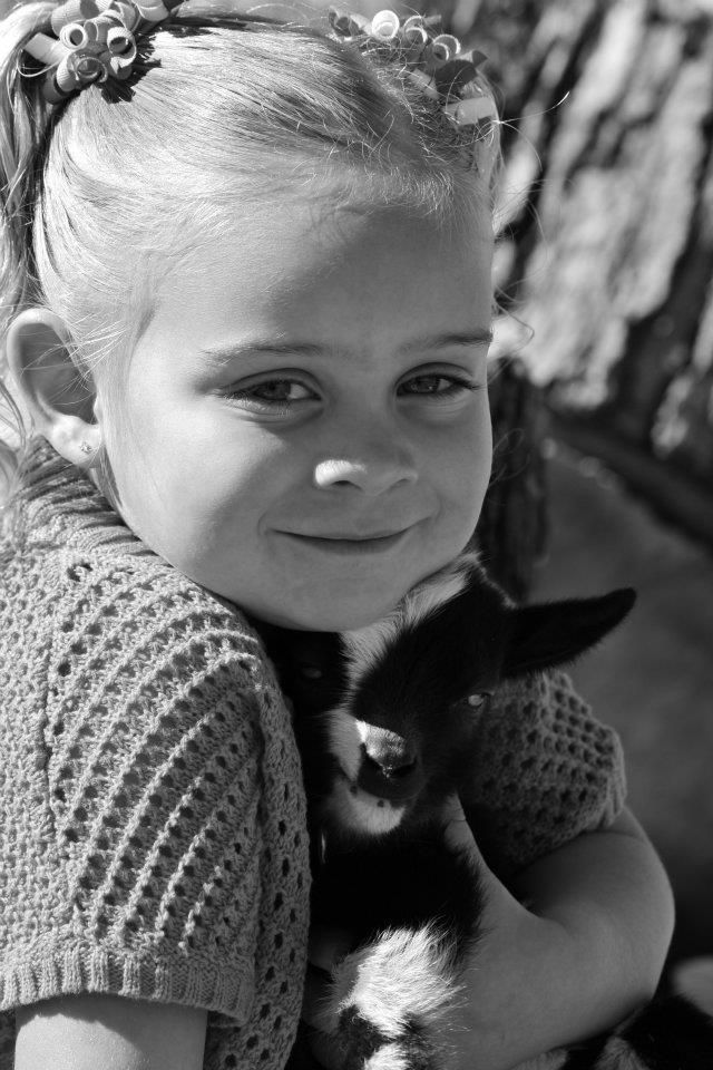 Series of black and white portraits showing interaction with a small dark-colored pet.