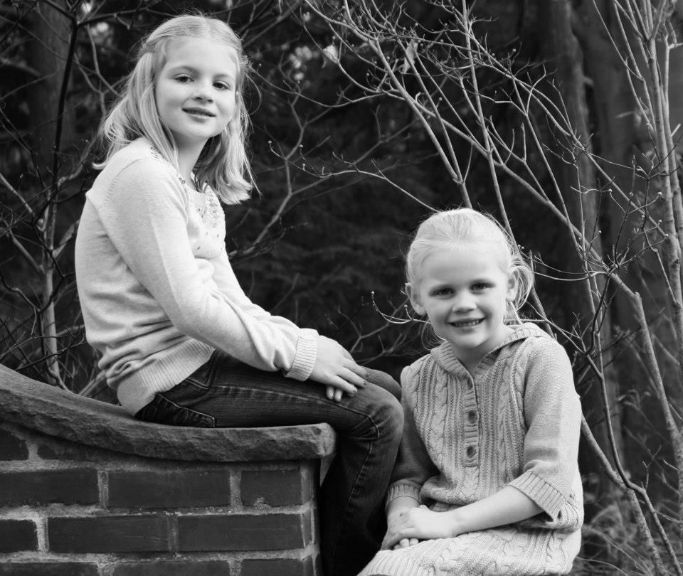 Black and white portrait series on a brick wall with natural lighting.