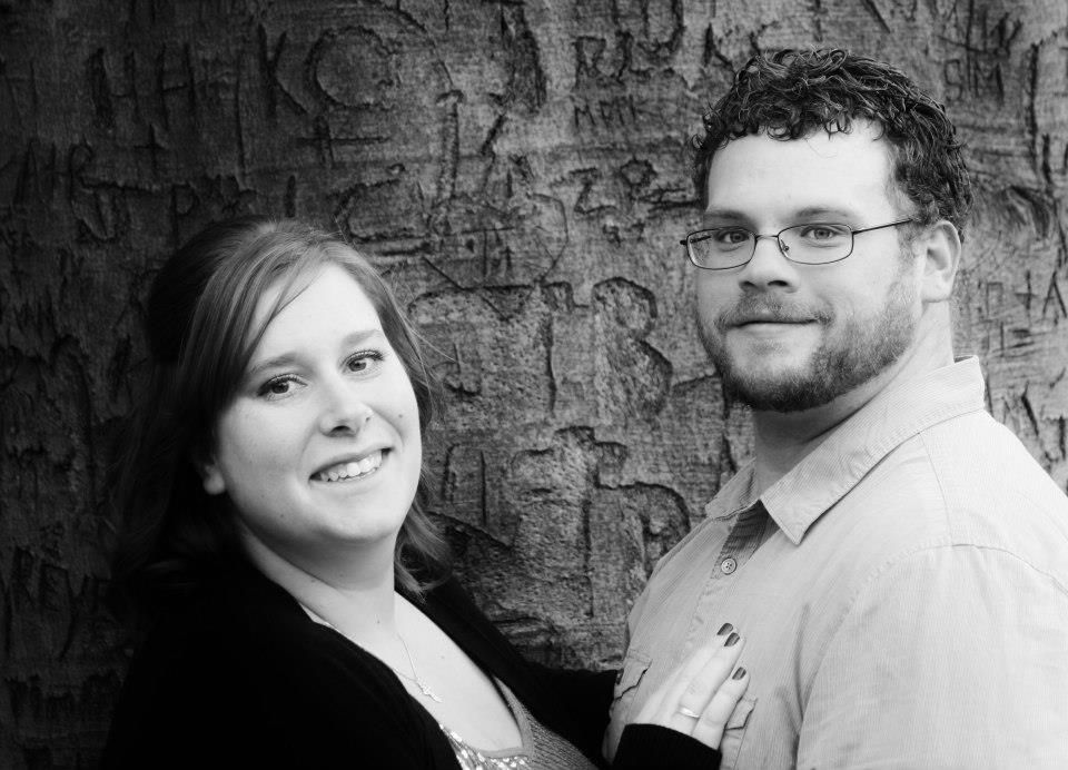 Black and white portraits against textured brick wall background.