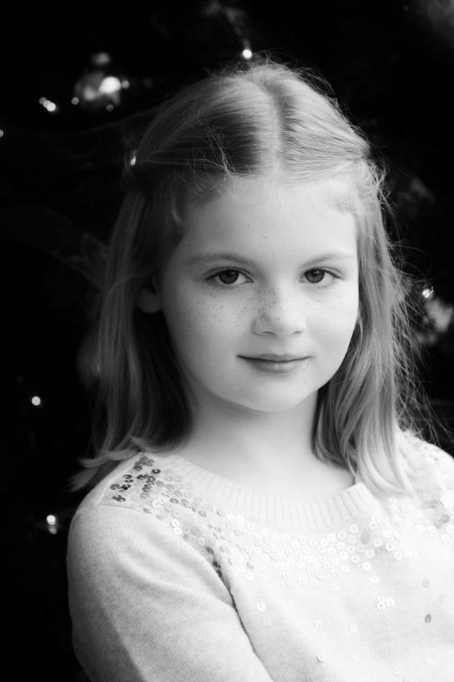 Black and white portrait with an embellished white sweater.