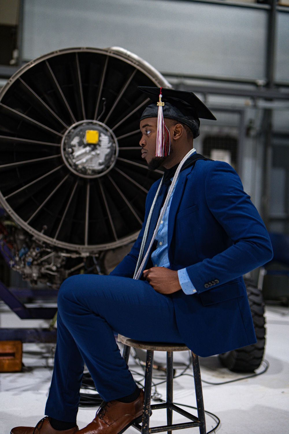 Graduate posing with cap and gown — milestone portrait by Timoy B Photography.