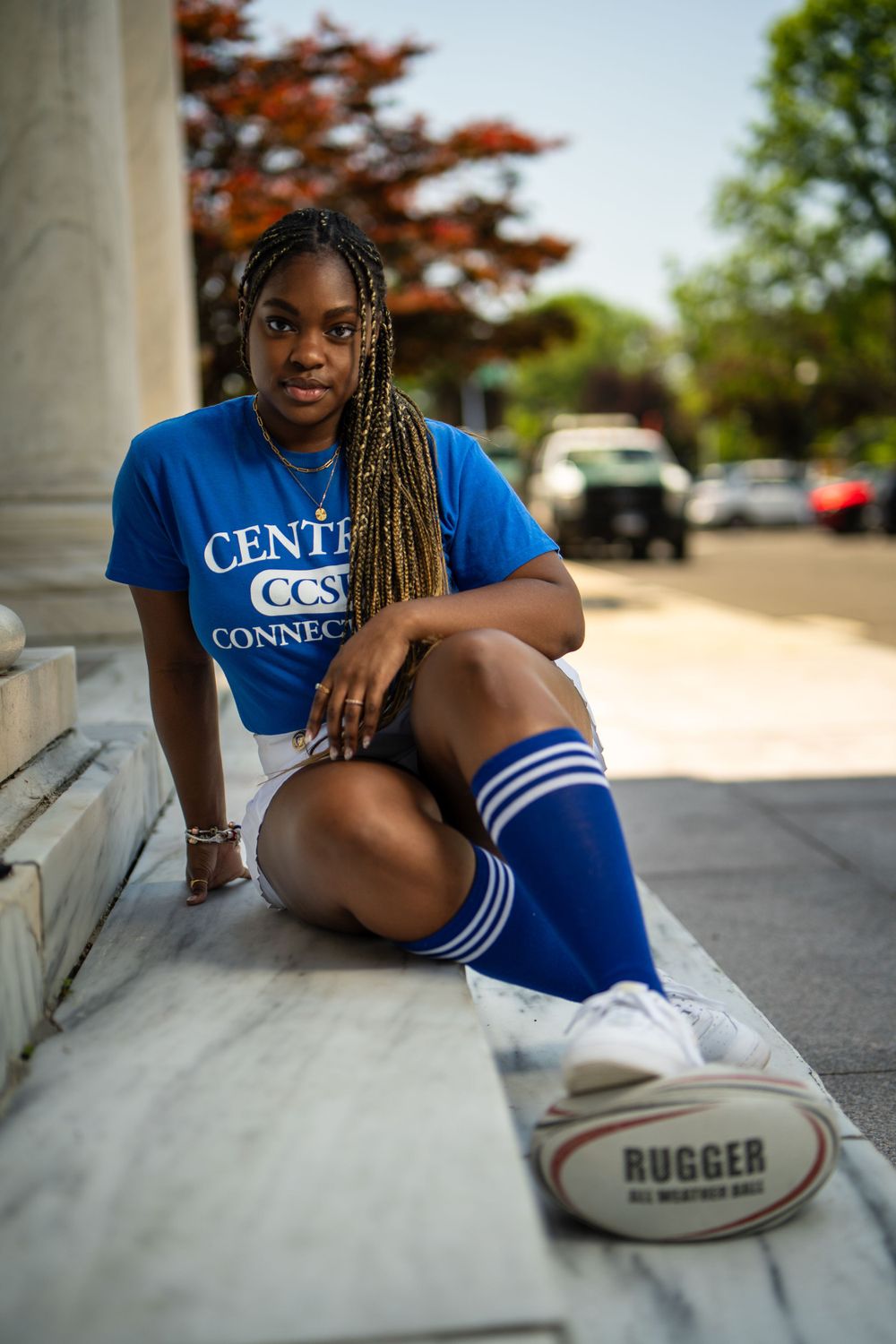 Graduate posing with cap and gown — milestone portrait by Timoy B Photography.