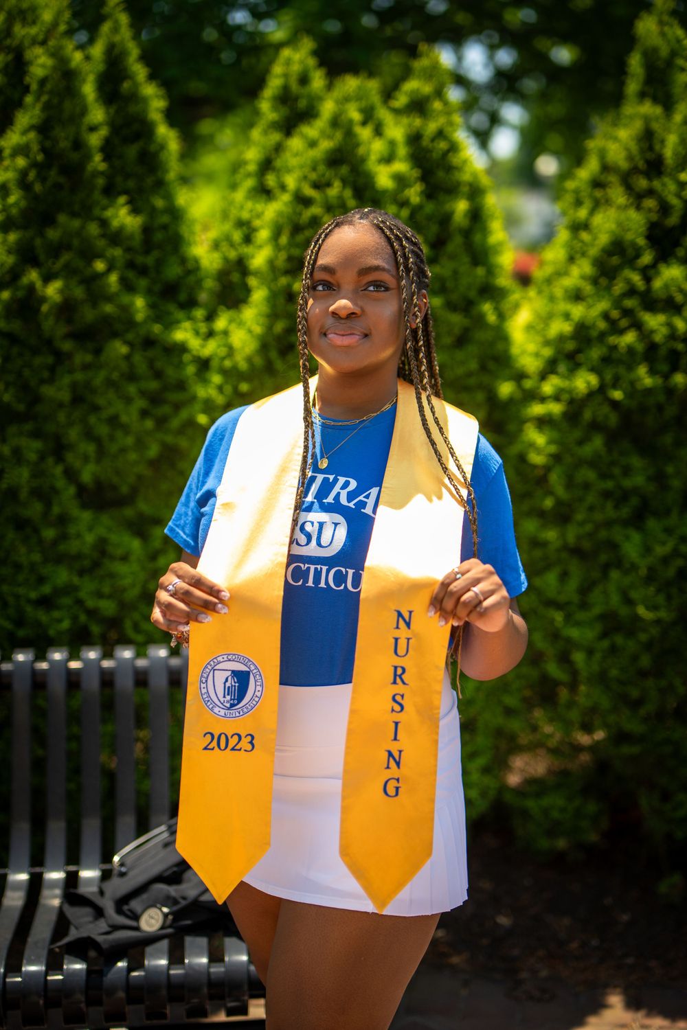Graduate posing with cap and gown — milestone portrait by Timoy B Photography.