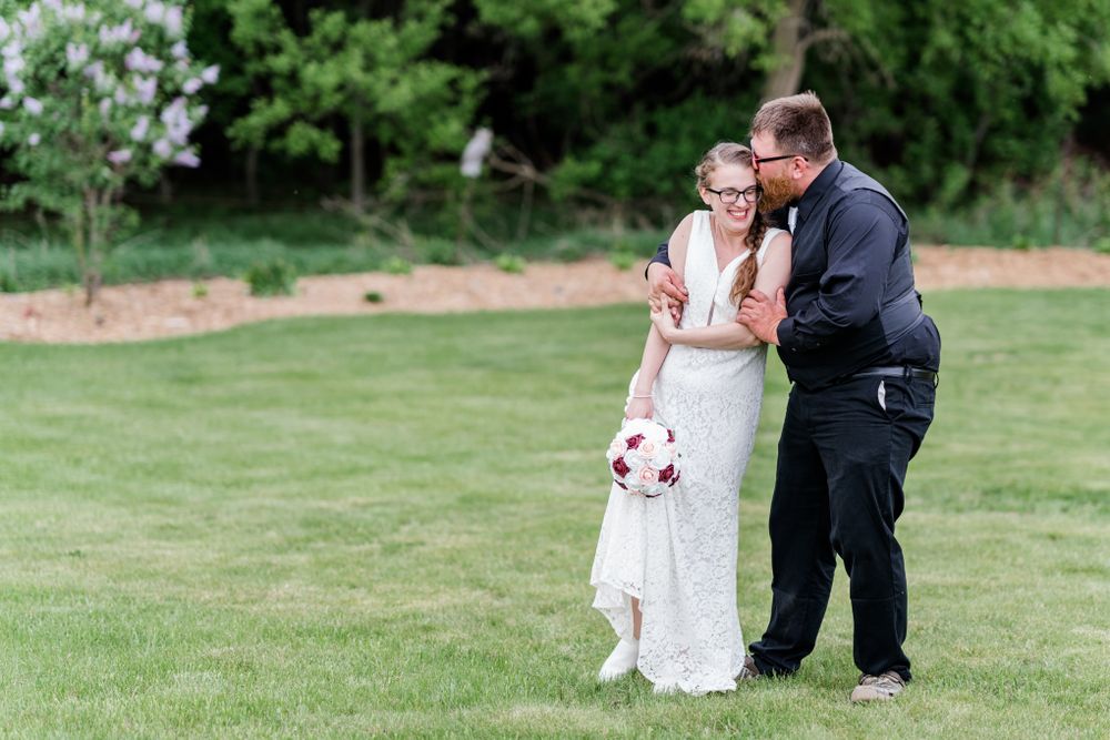 A joyful wedding moment captured on a spring day with pink floral bouquet.