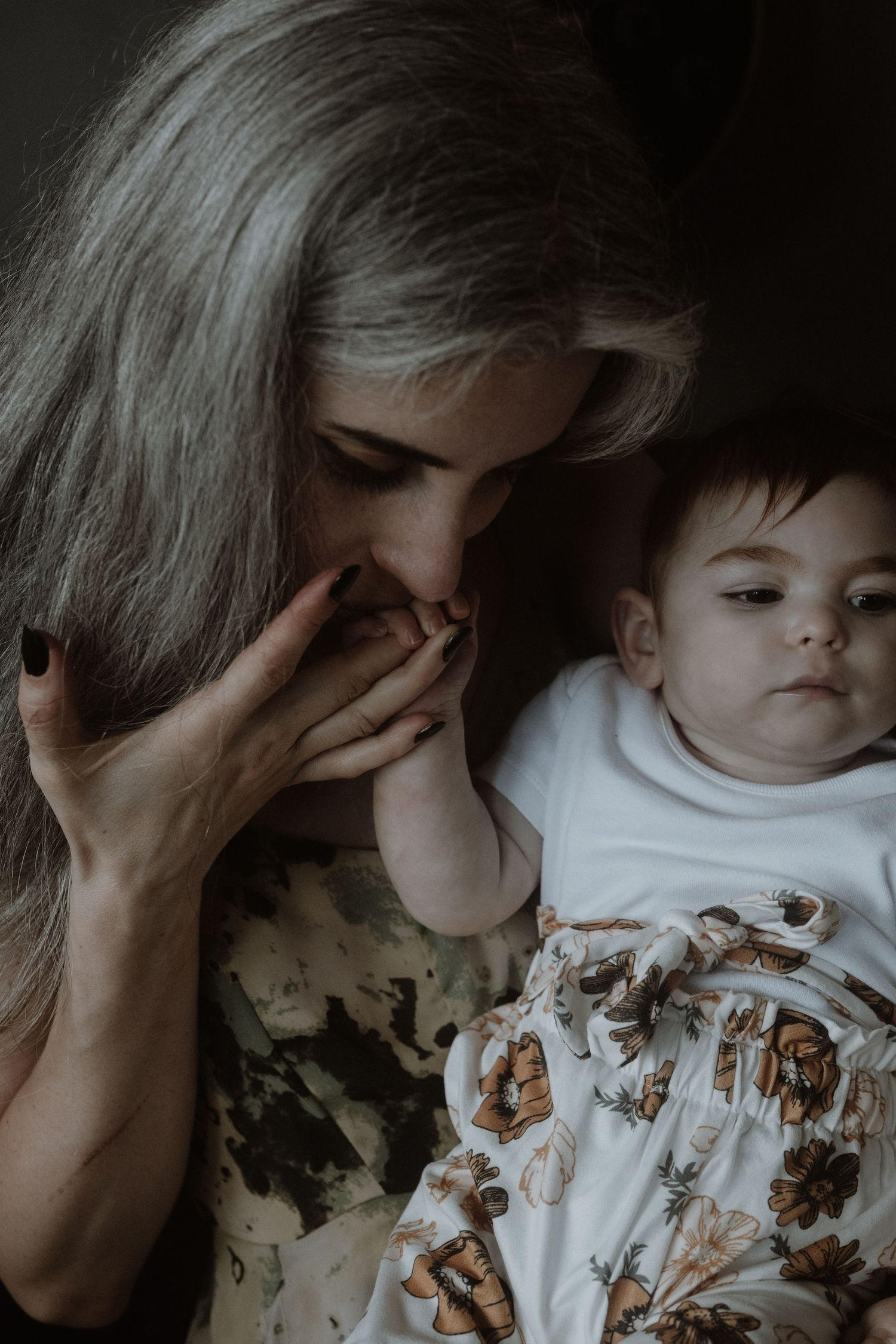 An emotional portrait showing a tender moment between a young child and adult.