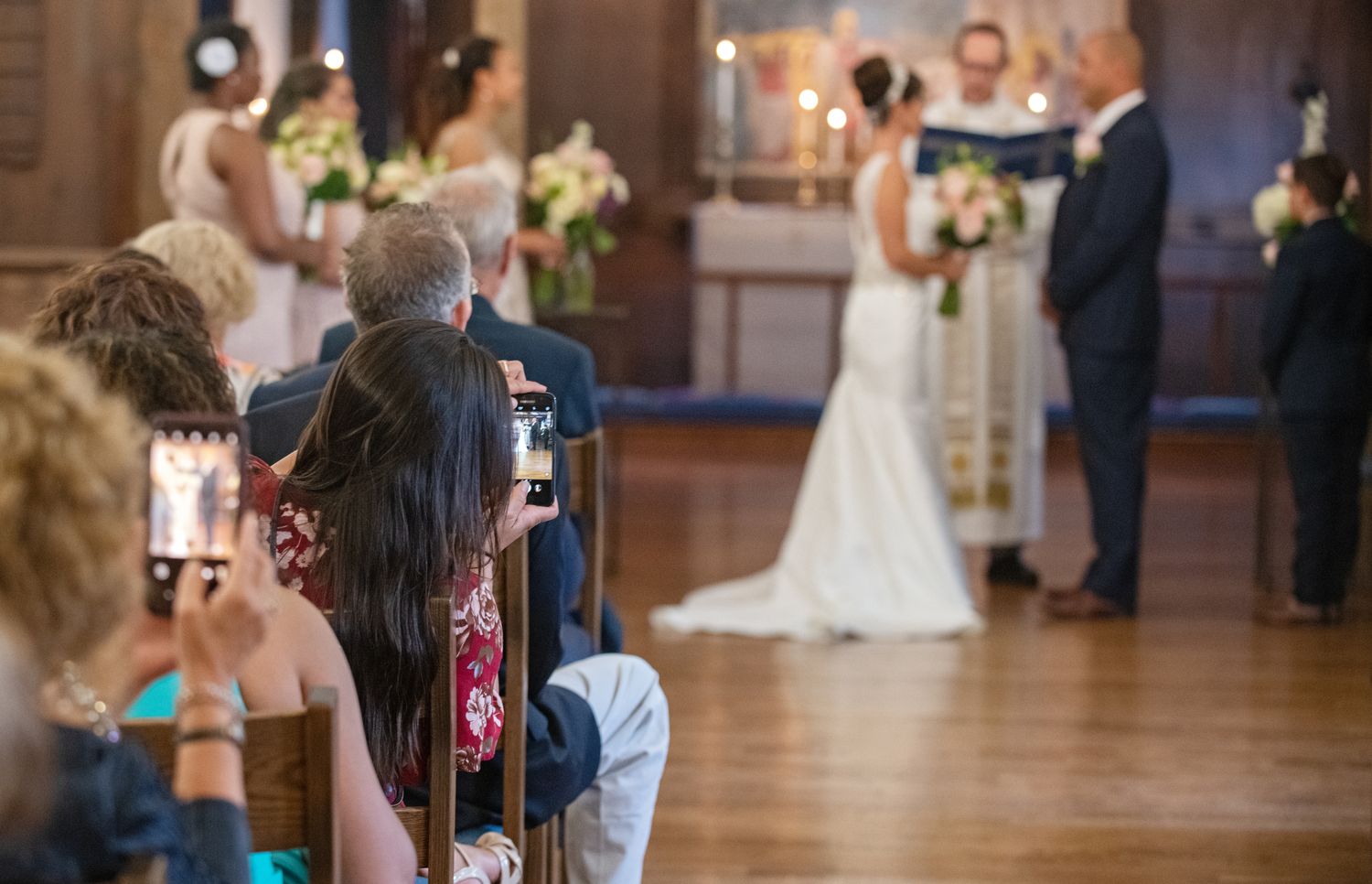 Wedding reception venue with wooden floors and elegant decor.