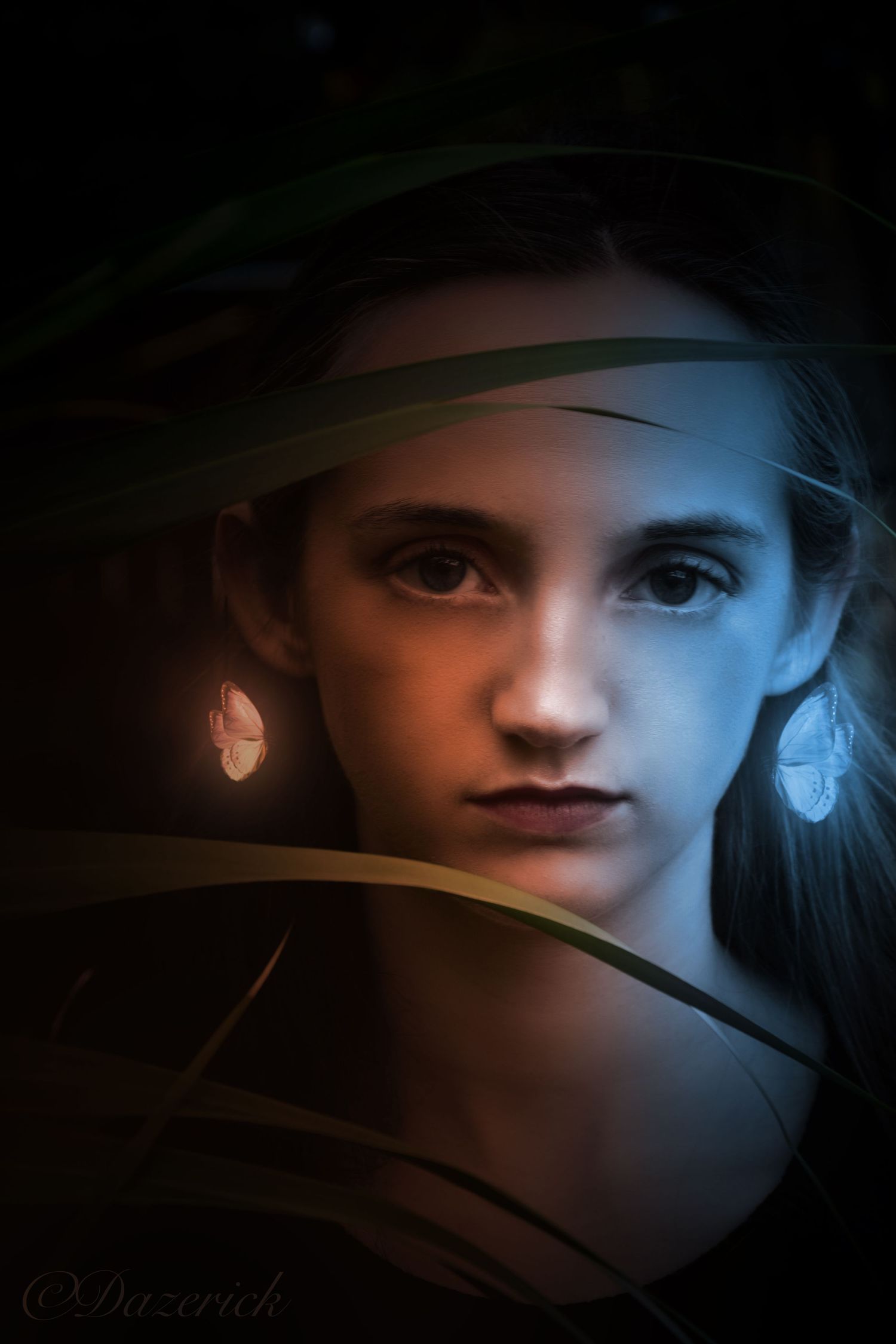 Artistic portrait with dramatic lighting combines cool blue tones with warm oranges in a shadowy composition.