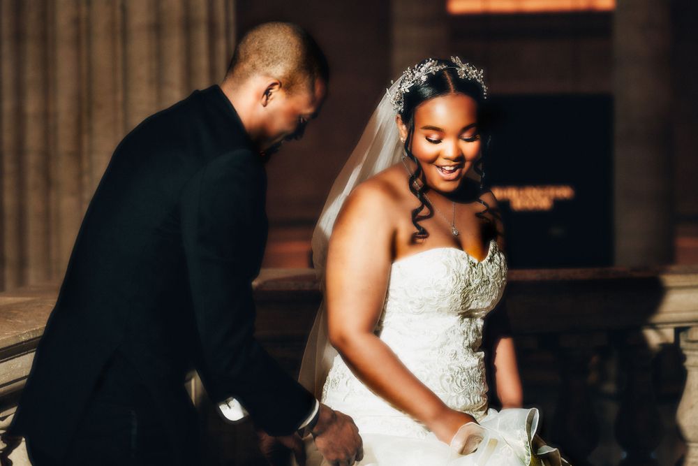 Wedding ceremony scene with formal attire in an elegant indoor venue.