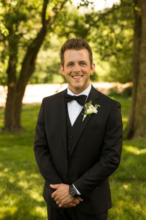 Formal portrait in lush green garden setting.