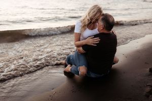 couple embracing, forehead to forehead at the lake during sunset