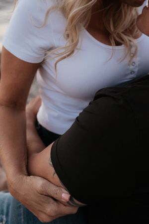 close up of a couple embracing at the lake during sunset
