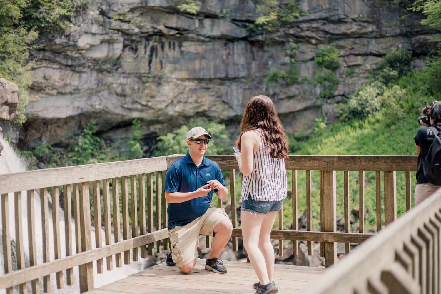 Surprise engagement proposal photographed at scenic state park overlook.
