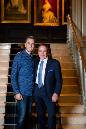Professional photos on elegant marble staircase with classical interior backdrop.