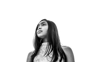 Black & white image of girl looking out @ the water, during a family session on the rooftop of the Butler Garage Seattle