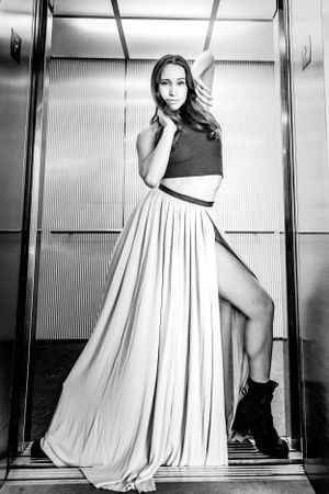 Black and white image of a dancer posing in an elevator in a long skirt: Dance Session near the Sculpture Park, Seattle