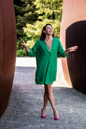 Olympic Sculpture Park, Seattle: rust wave walls with model standing in green dress & pink heels. Inclusive photographer
