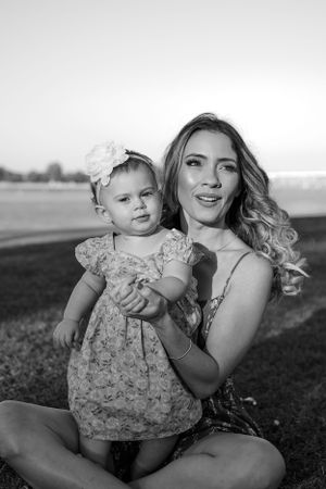 Black and white portraits of parent and child enjoying tender moments outdoors.