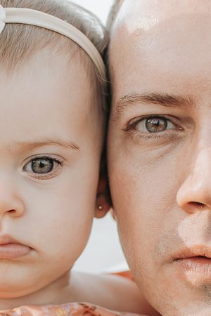 Intimate close-up portrait showing bond between parent and baby.