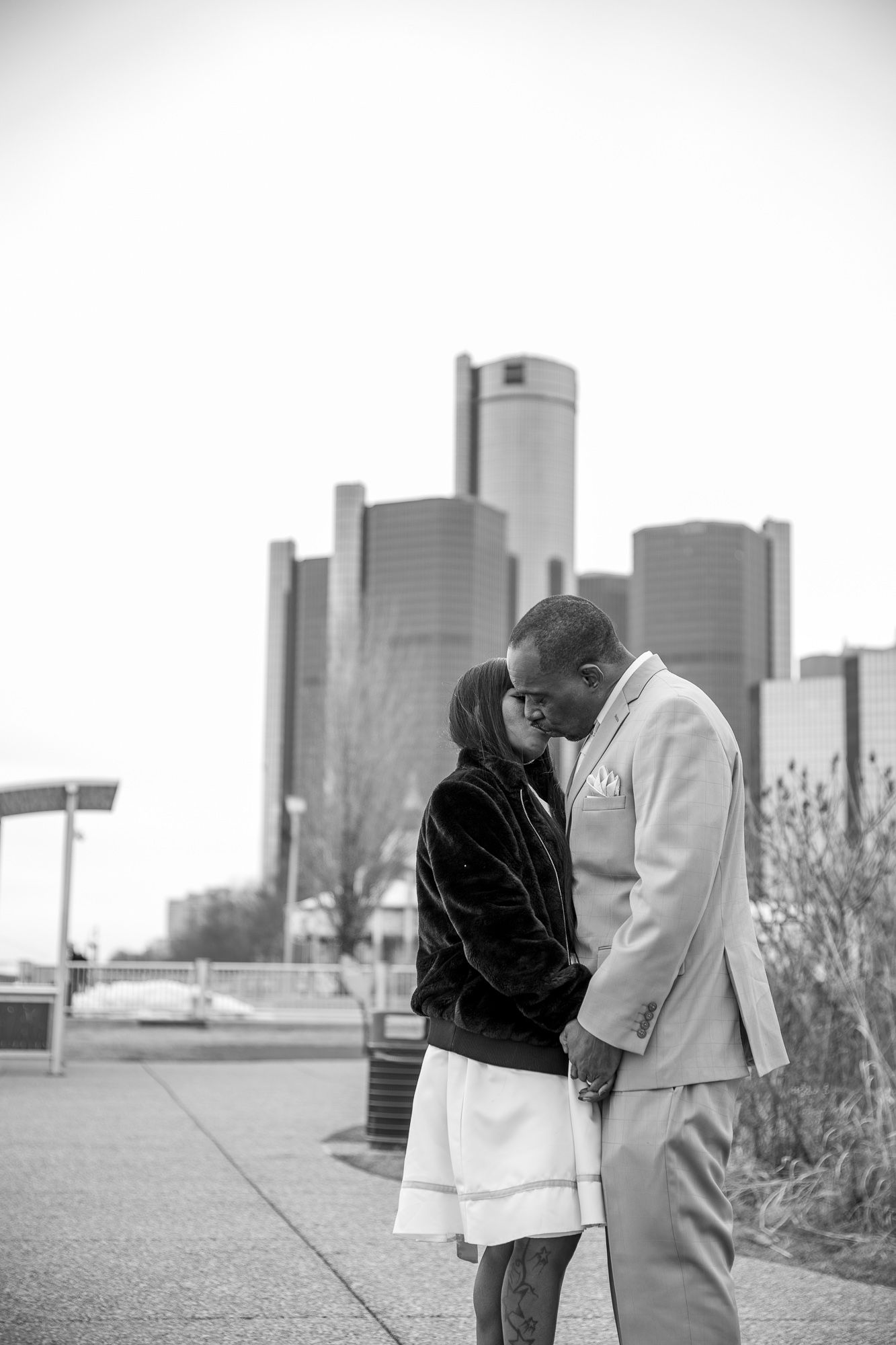 Husband and wife kissing downtown detroit