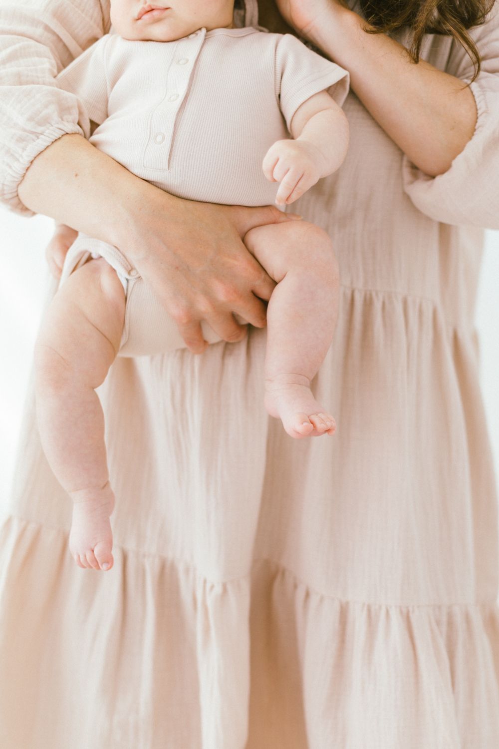 Delicate portraits highlighting soft pink clothing and tender interactions.