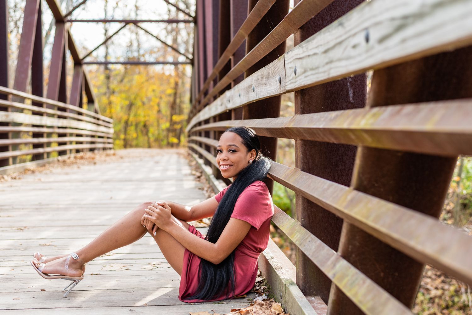 Beautiful black woman smiles on bridge.