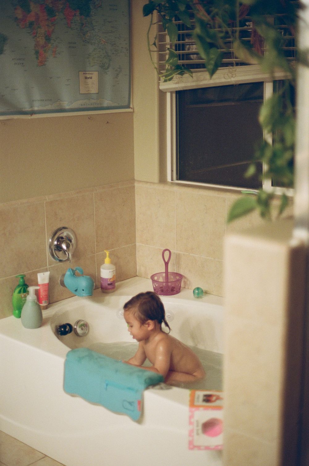 A child's bathtime scene with floating toys and bath accessories.