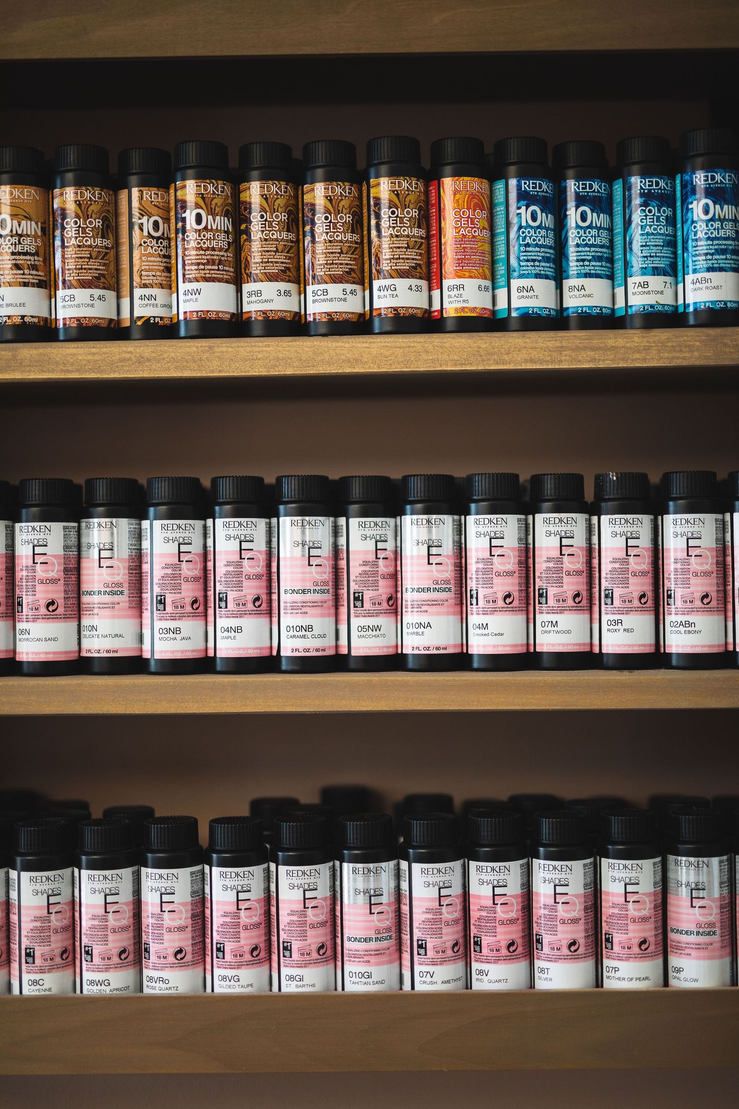 Organized shelves of hair color products lined up in neat rows.
