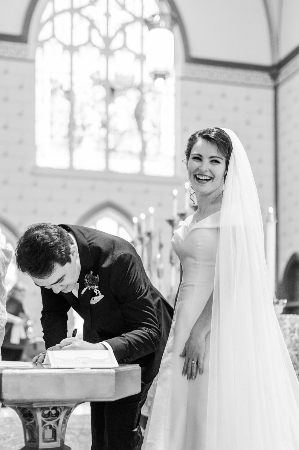 Husband and wife sign marriage license after their wedding at Holy Family cathedral in Tulsa, Oklahoma.