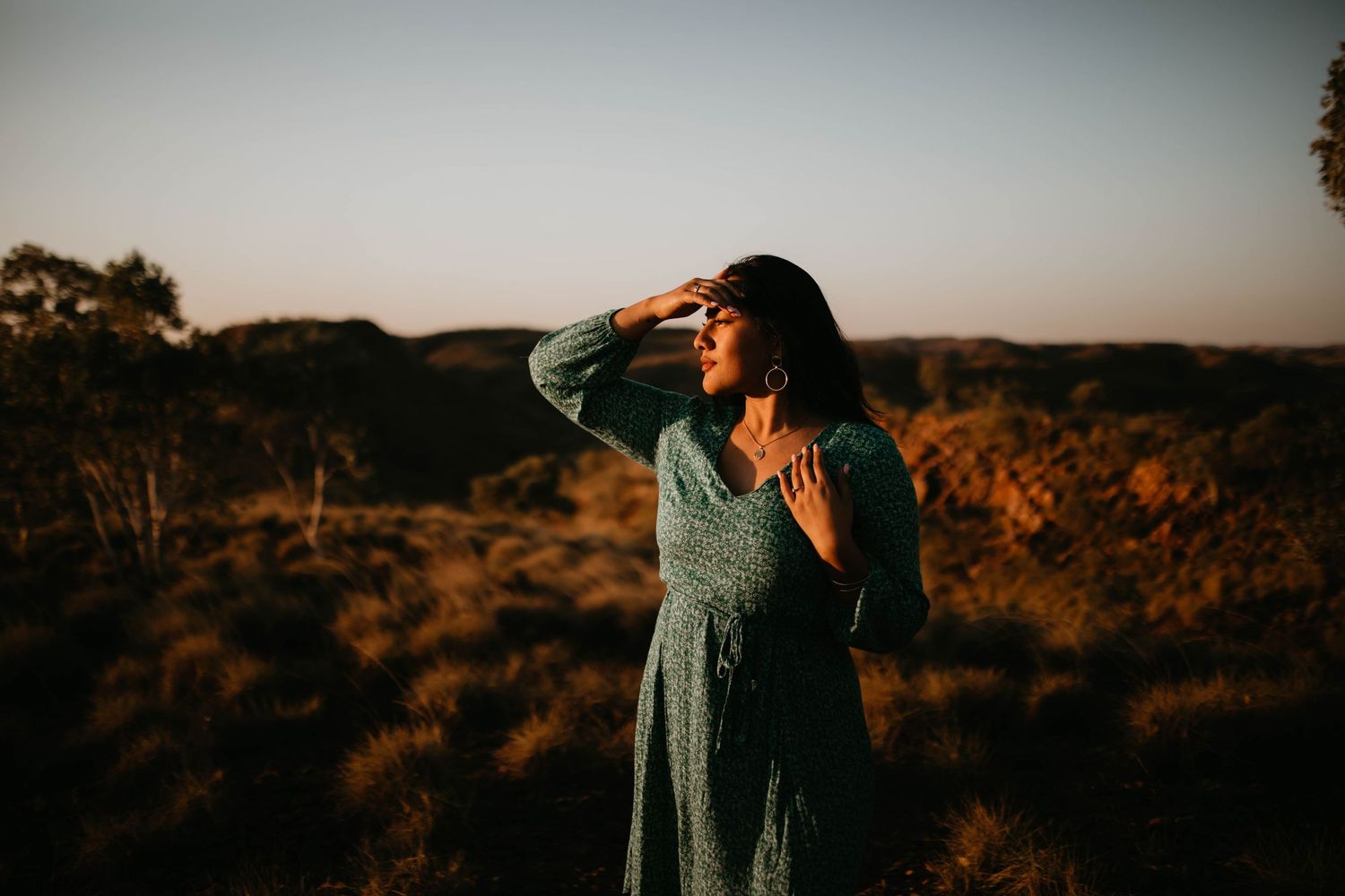 Woman in the desert looking to the sunset in Mount Isa at Telstra Hill