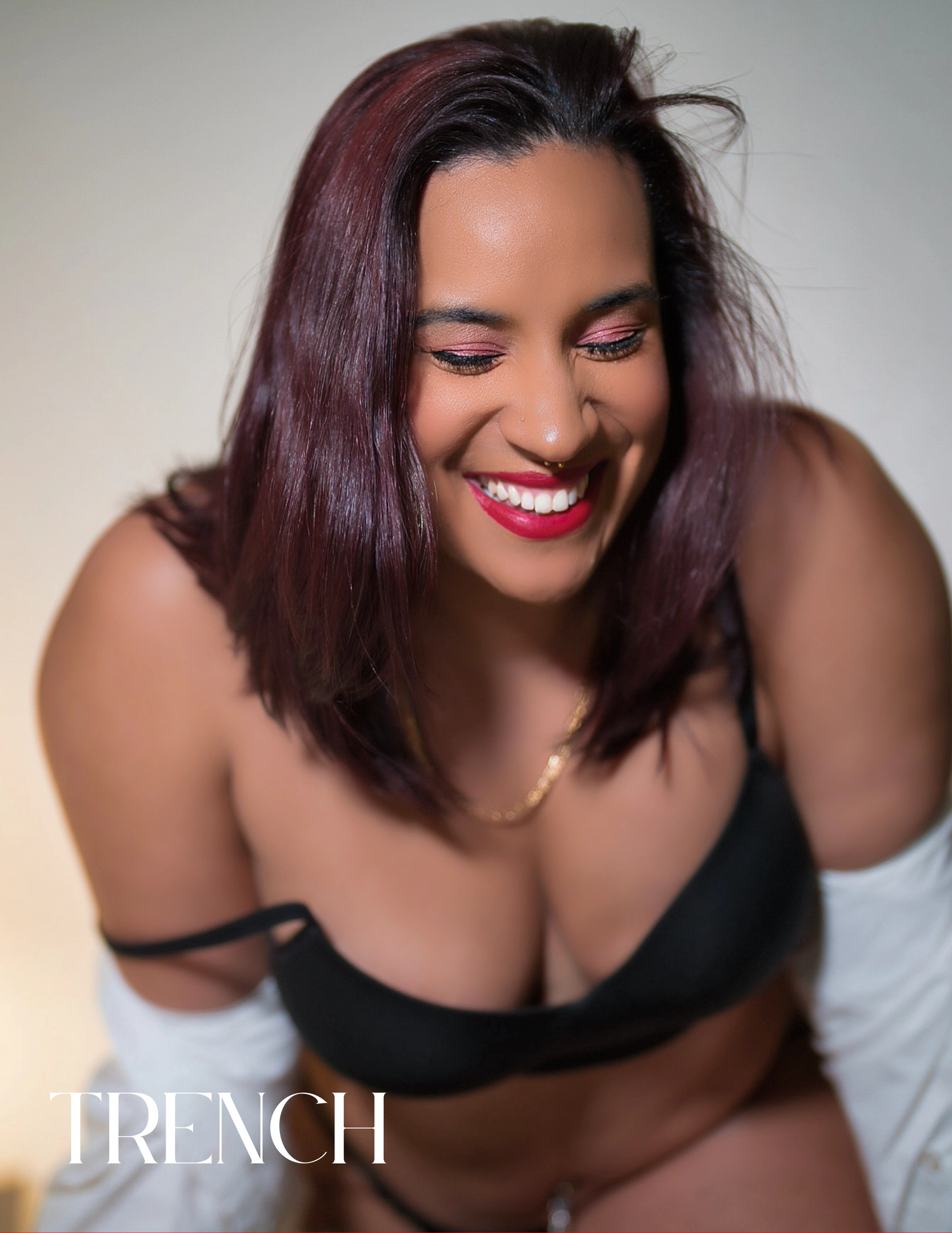 Studio beauty portrait with burgundy hair and bright red lipstick.