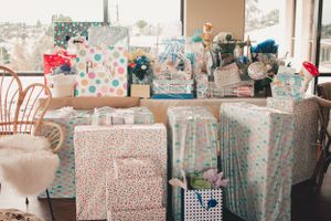 Baby shower gift table with wrapped presents in blue and white patterns.