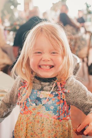 A joyful expression captured in warm lighting during a celebration.