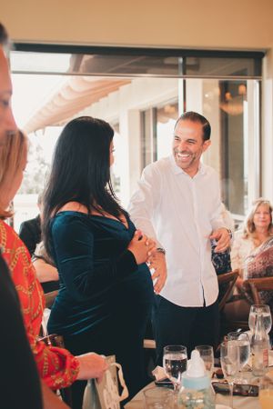 Guests engaging in conversation at an elegant dining event with table settings.