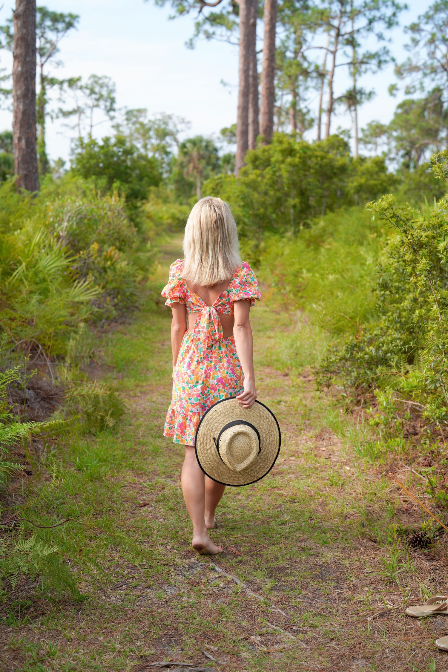 sandy beachfront candid portrait sunhat