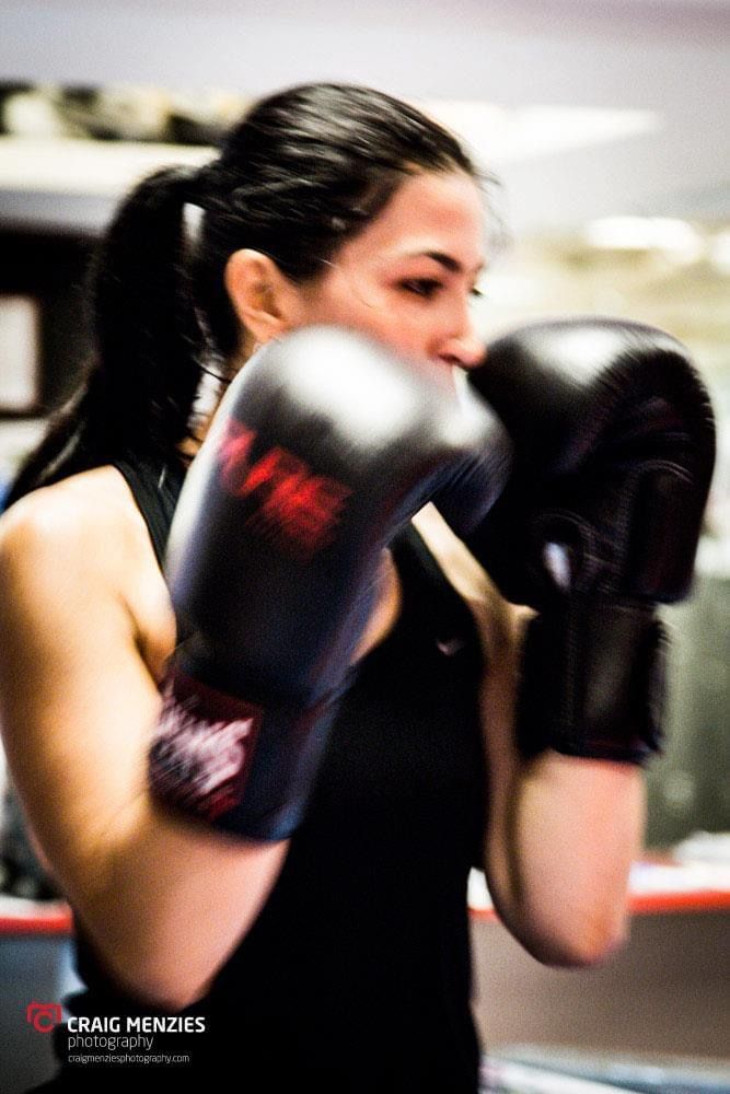 Female boxer throwing a punch with motion blur effect captured at Craig Menzies Photography.