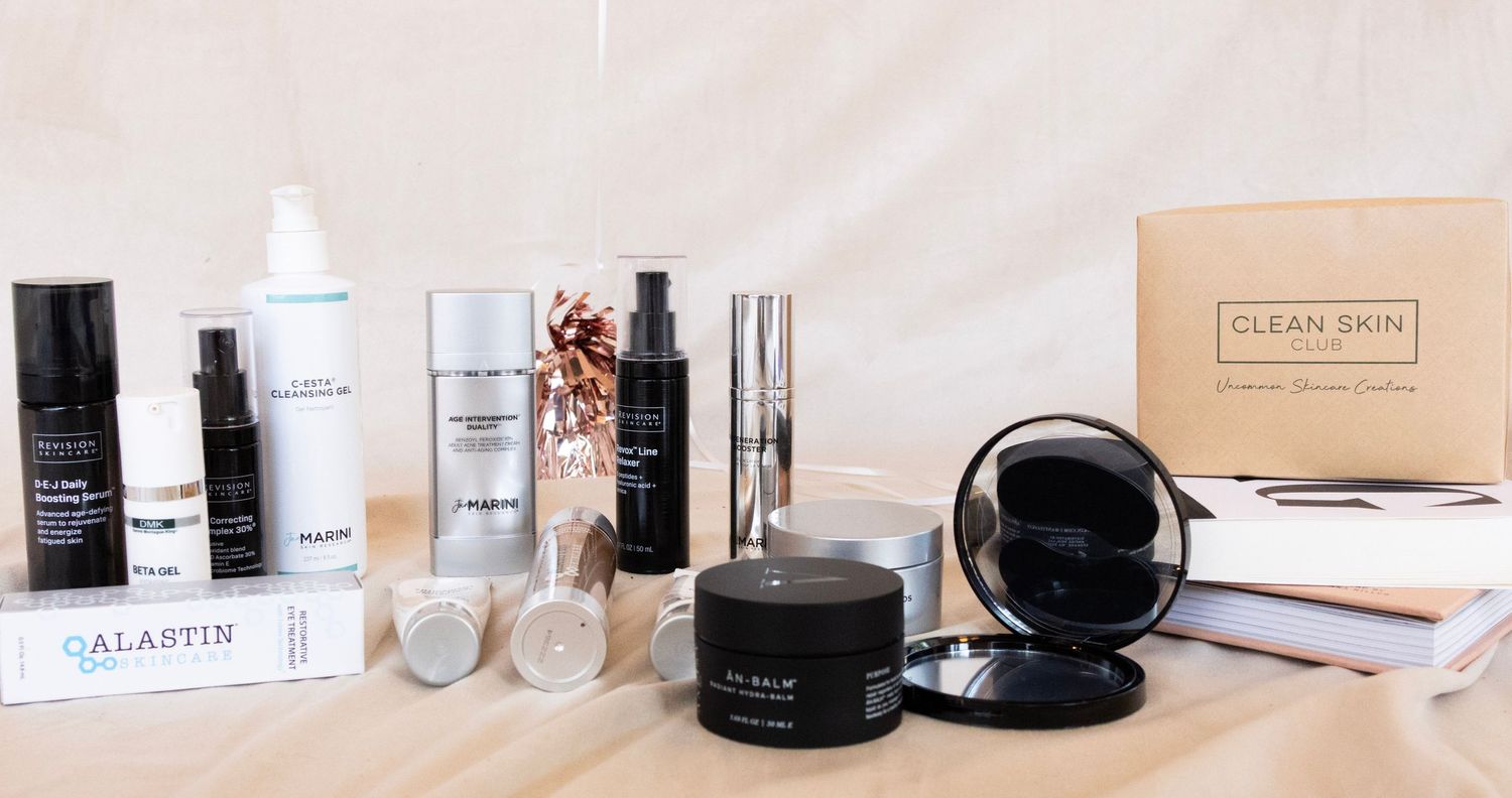 Collection of beauty products and skincare items arranged on white surface.