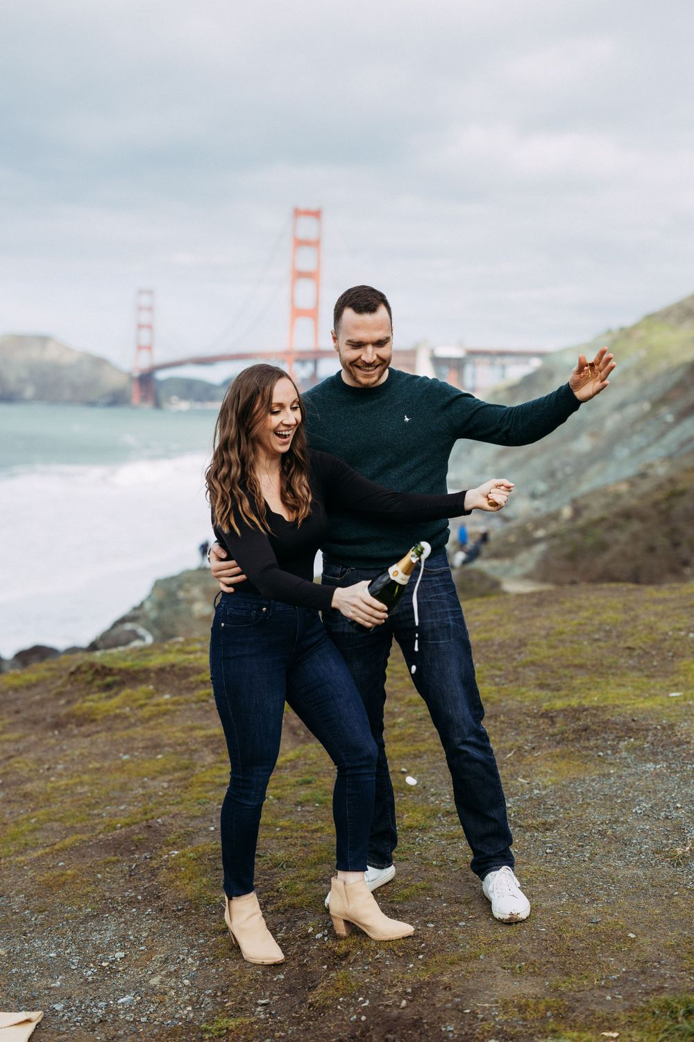 Champagne pop during engagement photos with Golden Gate Bridge